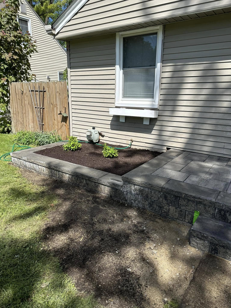Greener Grounds Landscape brick wall and patio and landscaping.